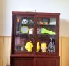 cabinet display multiple miniature art pieces 