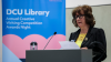 a woman speaks from a lectern