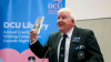 A man reads from a lectern