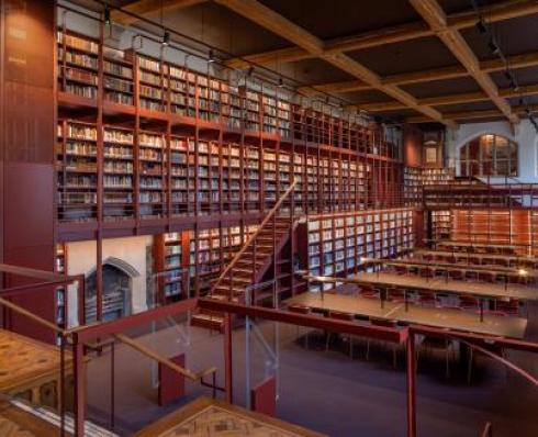 Wooden library with soft warm lighting displaying thousands of books