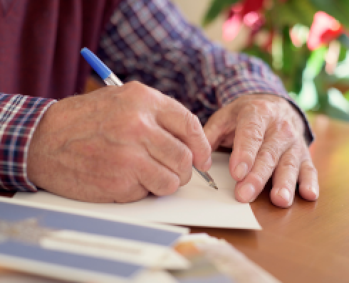 Hands writing on a page