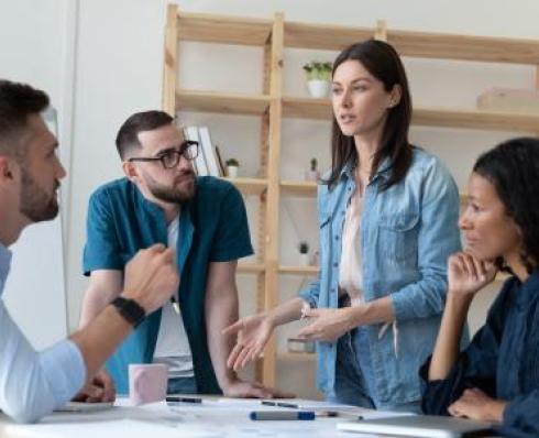 Colleagues in conversation at a table