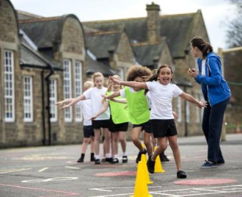 Shows school children in yard