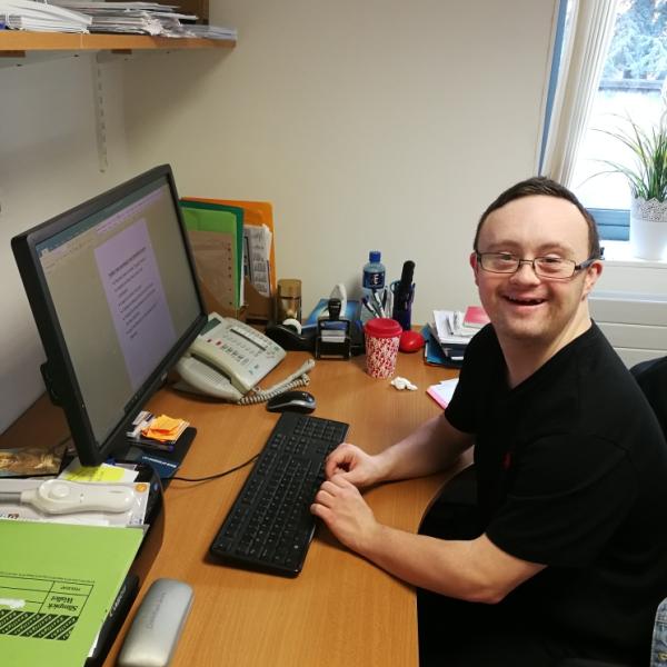 Photo of learner working on computer during placement at the Interfaith Centre