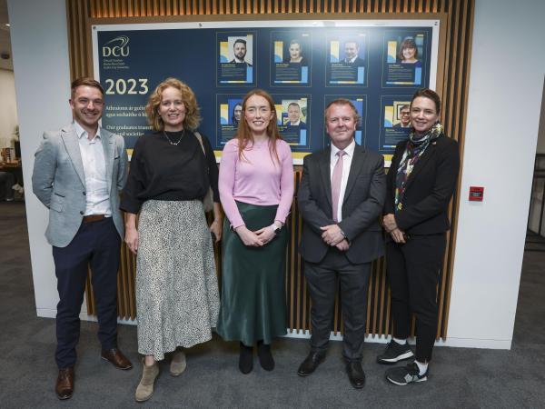 awardees with the alumni wall