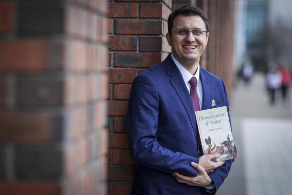 Shows Dr Gezim Visoka promoting his new book on DCU Glasnevin campus