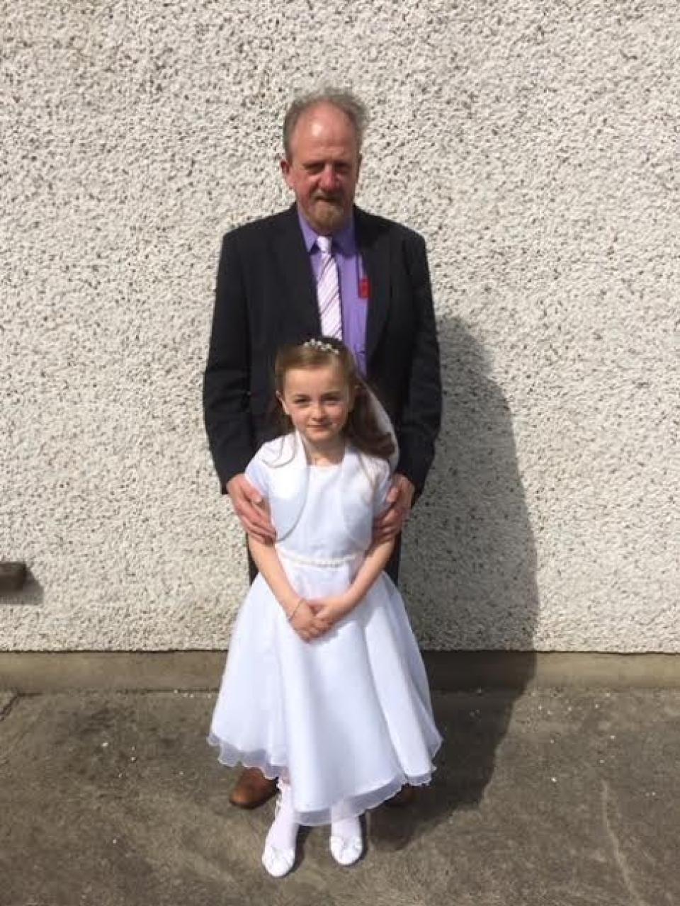 Tom McCann with his granddaughter at her First Communion