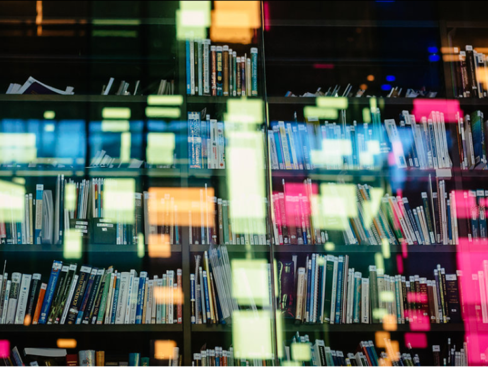 Books on shelf with colourful light reflections