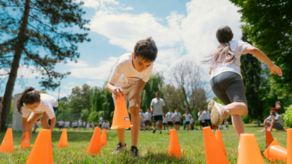 Children playing with cones in a field