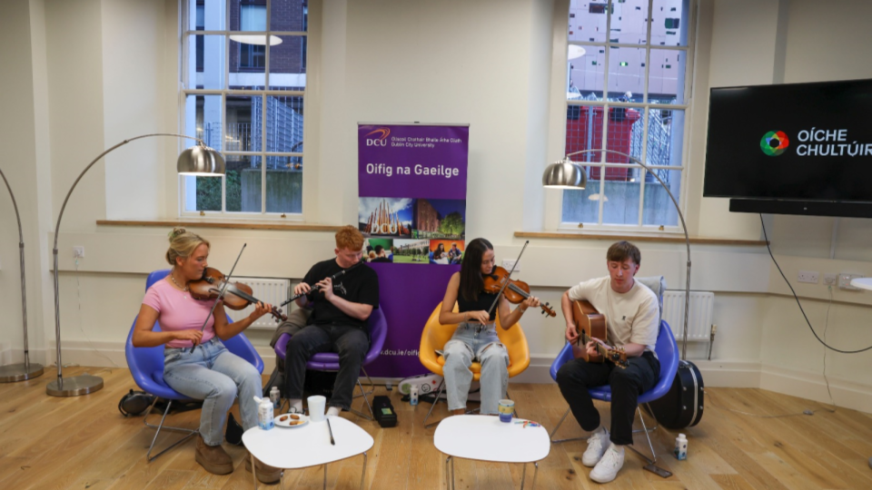 Four students playing musical instruments