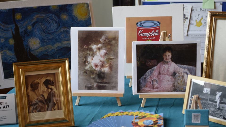 Selection of artworks displayed in frames on a table