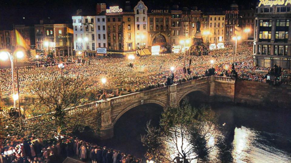 People gathered at night on O'Connell Street & O'Connell Street Bridge in Dublin 