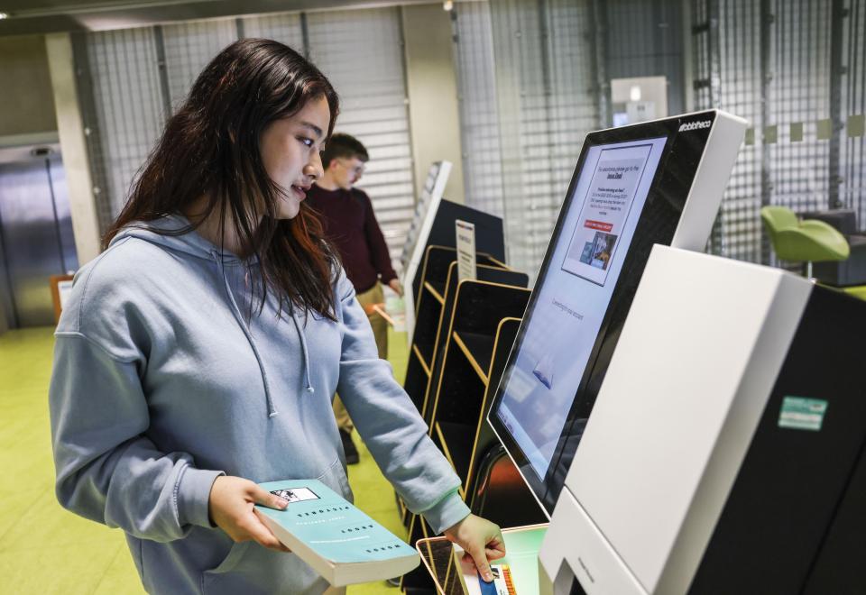 a student using the self service machine in Cregan library