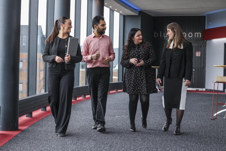 4 staff members walking 