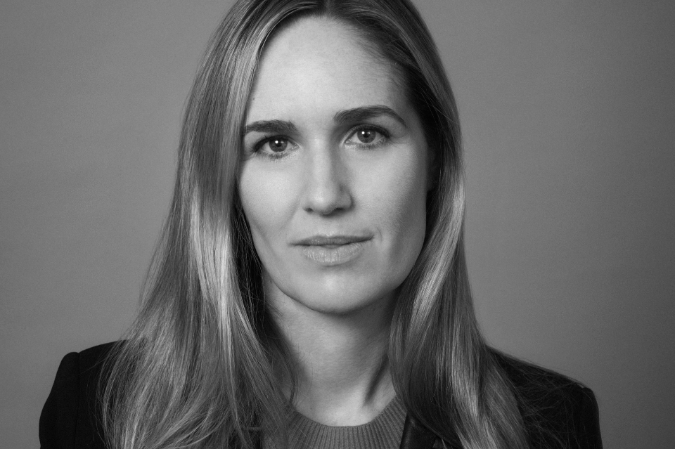 Black and white photo of woman with light hair to her shoulder 