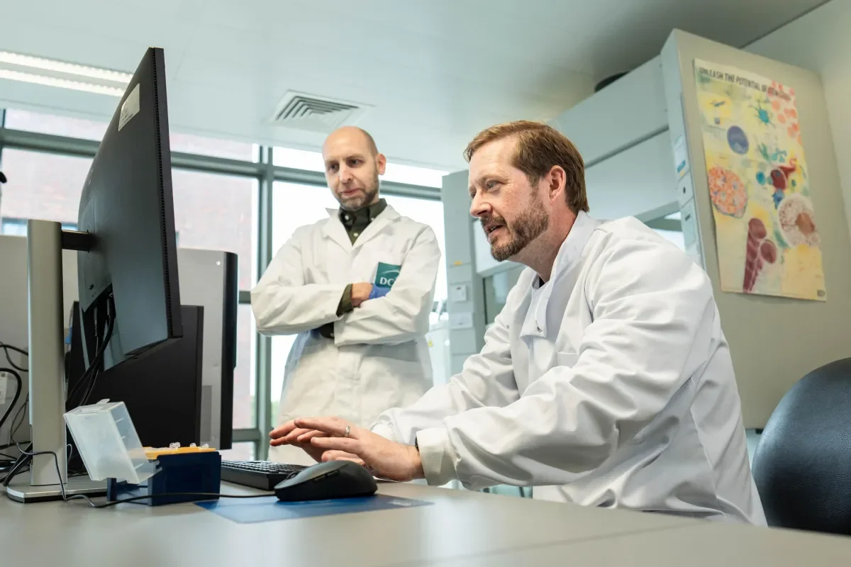 Shows Dr Alex Eustace and Dr Paul Buchanan at work in the lab