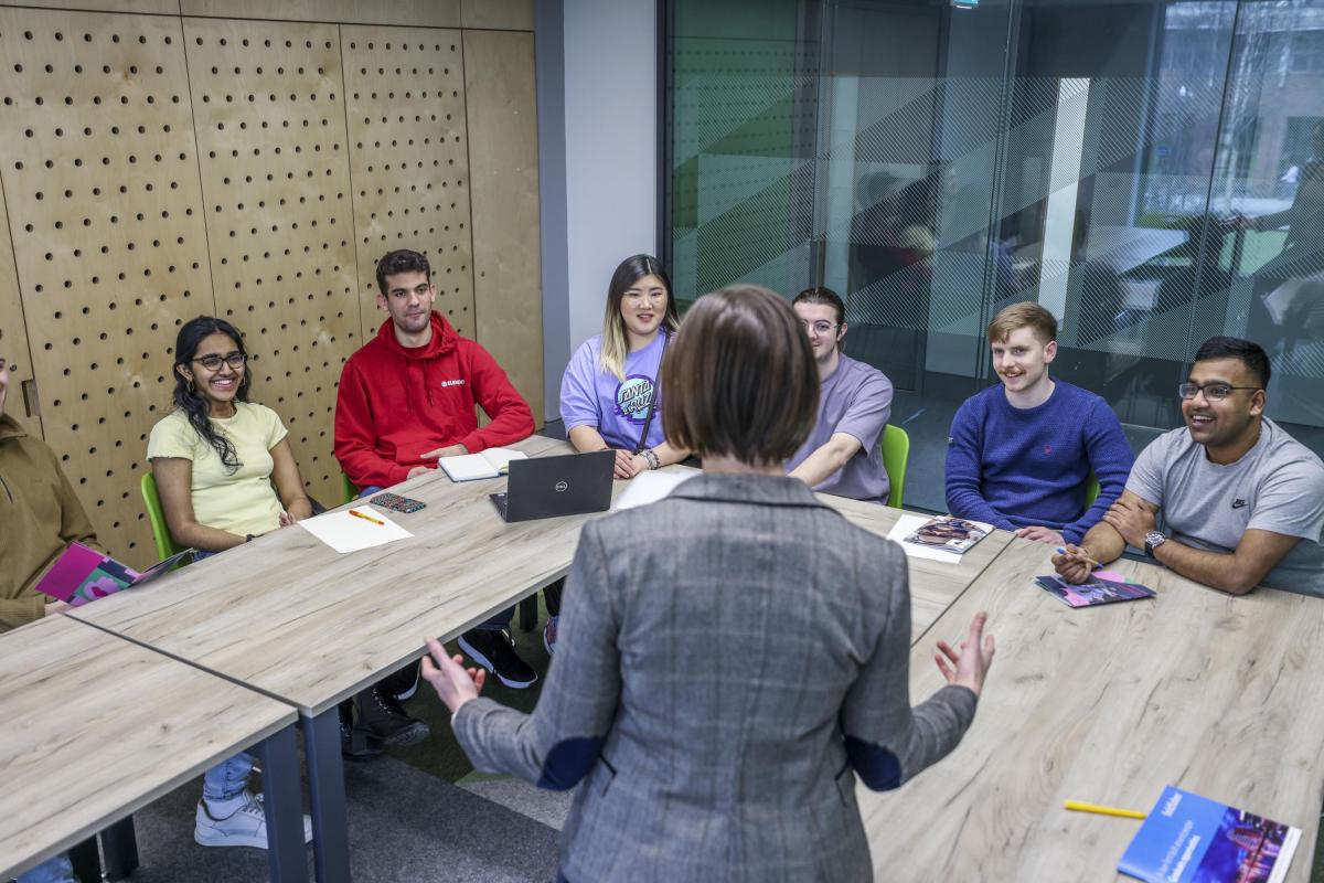 Teacher standing in front of university students in a classroom