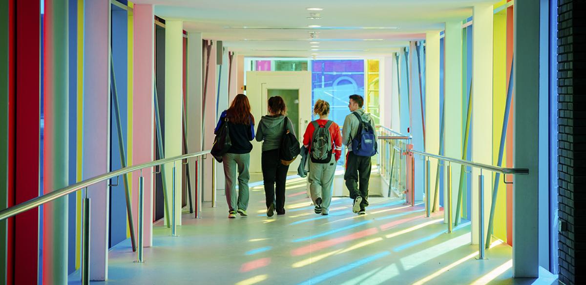 Four students walking down a corridor in Saint Patrick's campus