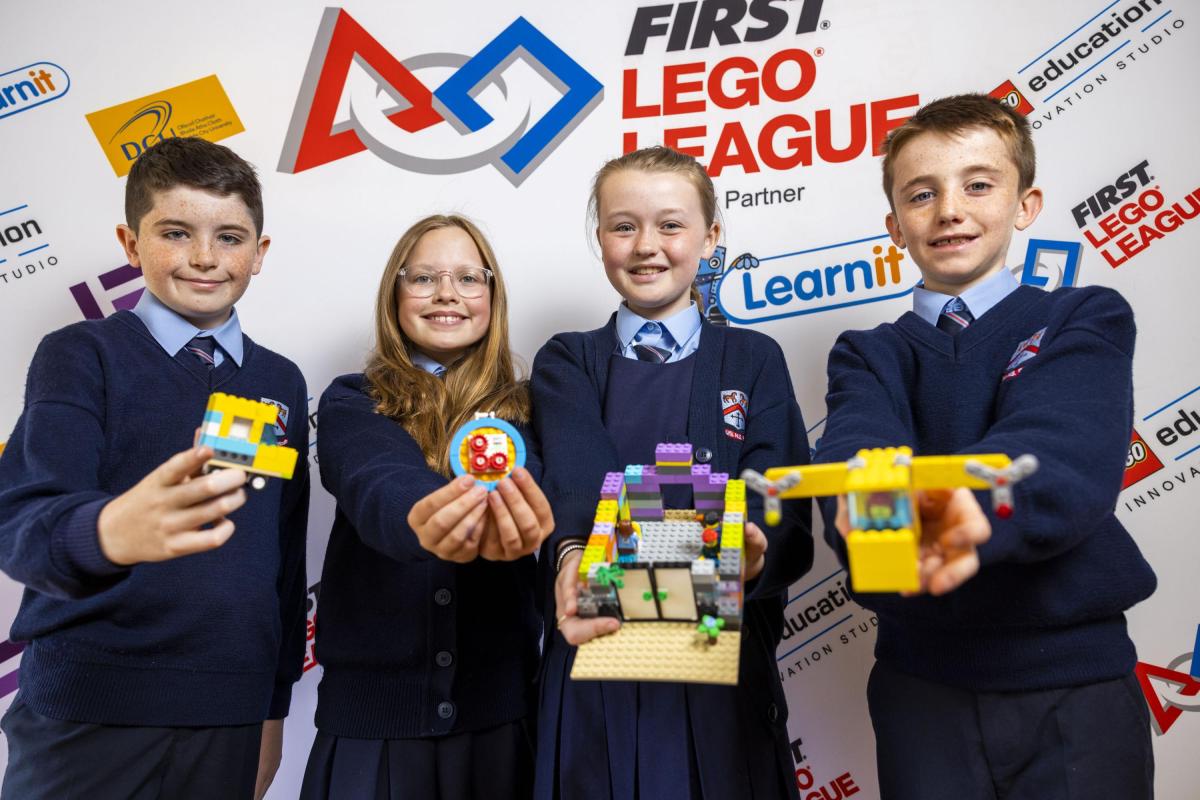 A group of students display their work at the LEGO showcase in DCU