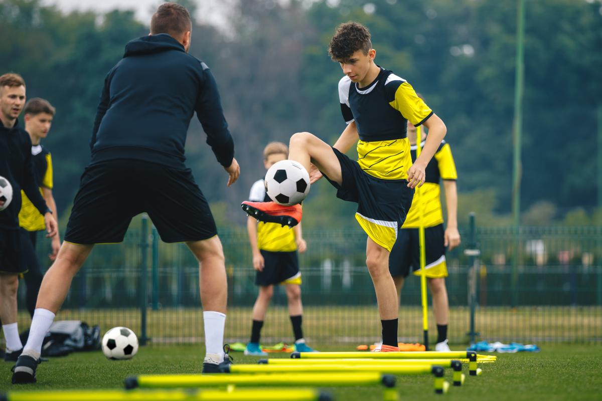 Young football players participating in warm up exercise