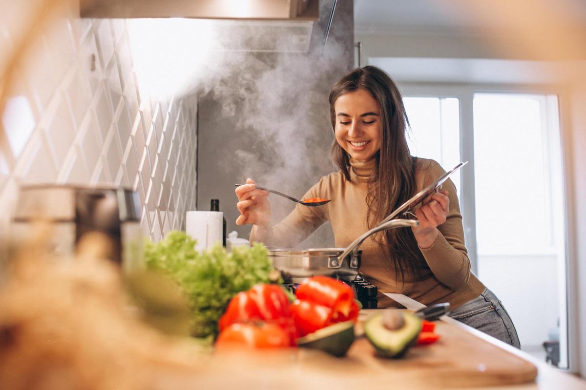 a woman cooking and smiling