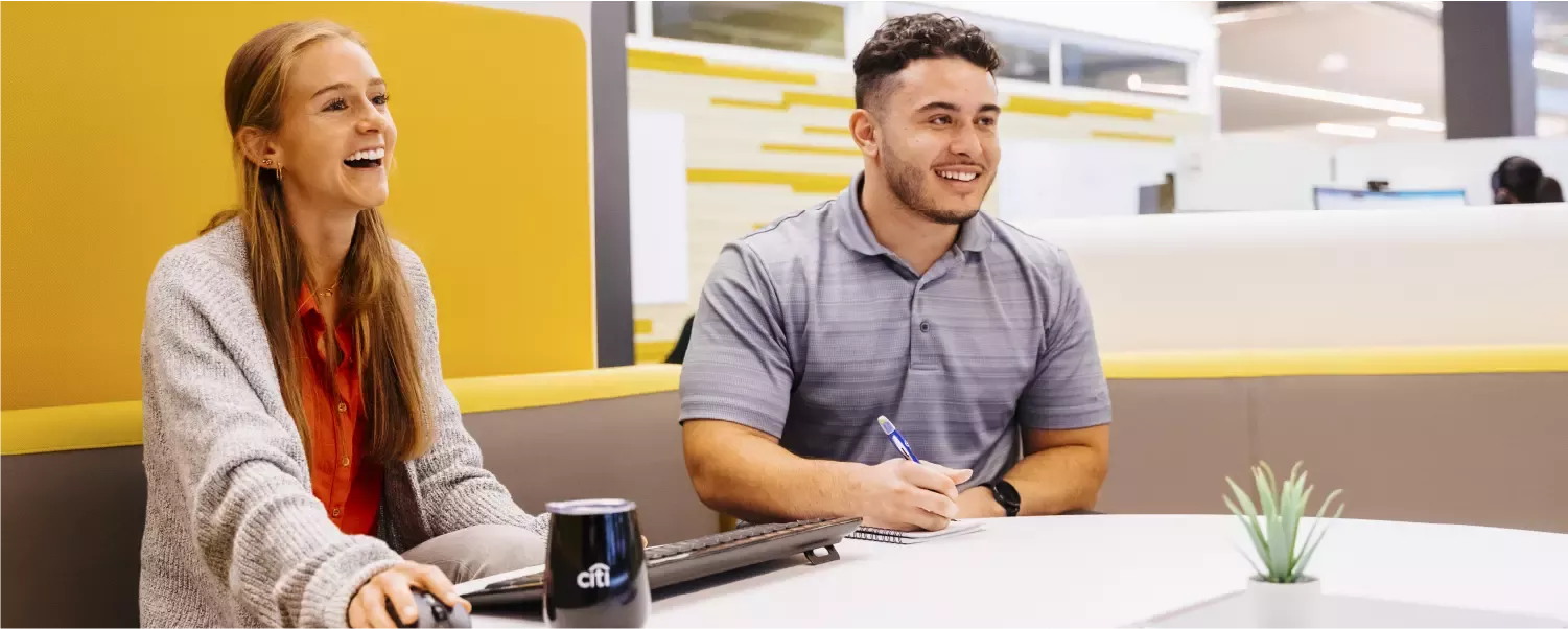 Two Citi interns at a meeting, enjoying the working environment