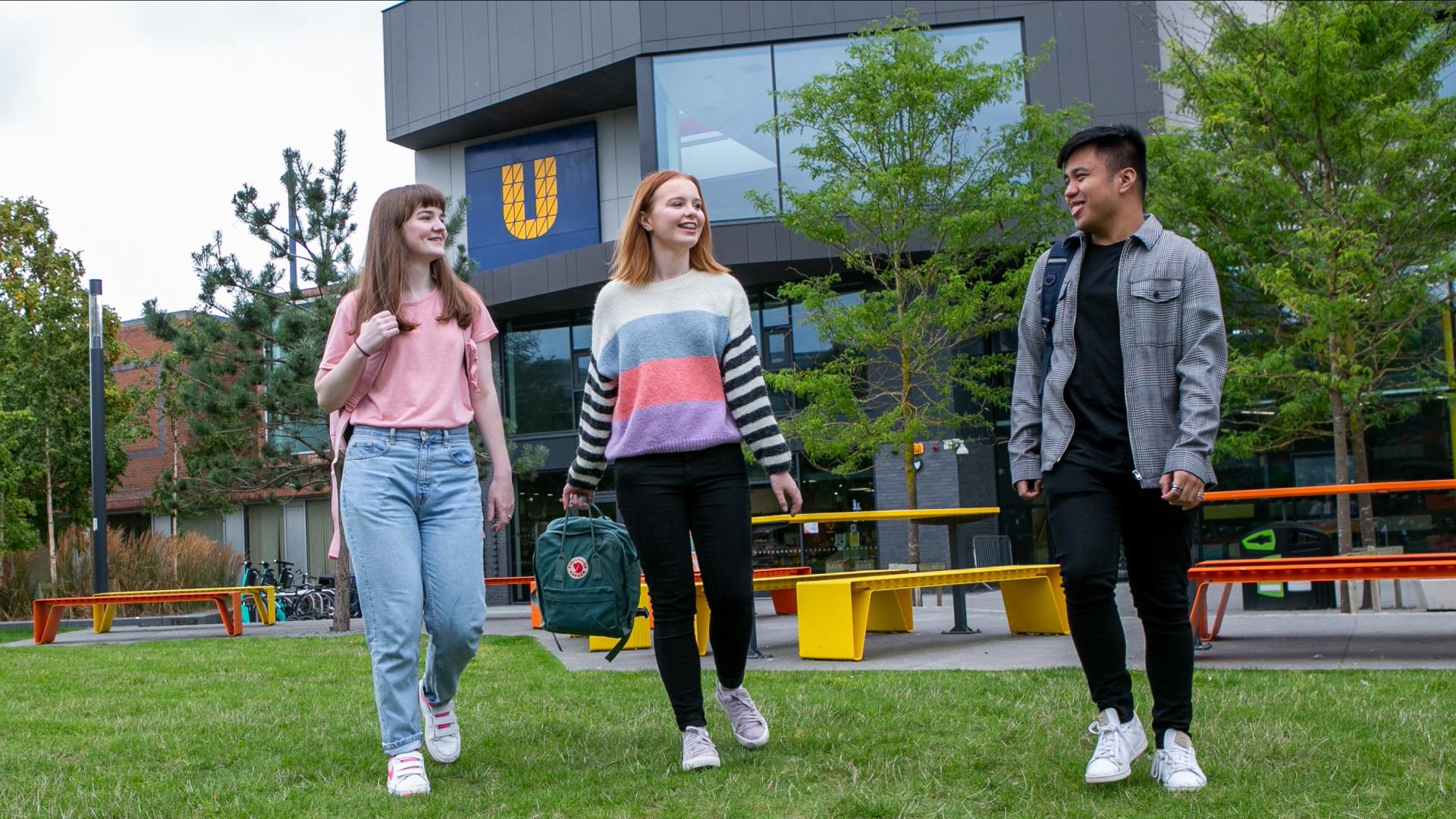 Image of three students walking around campus