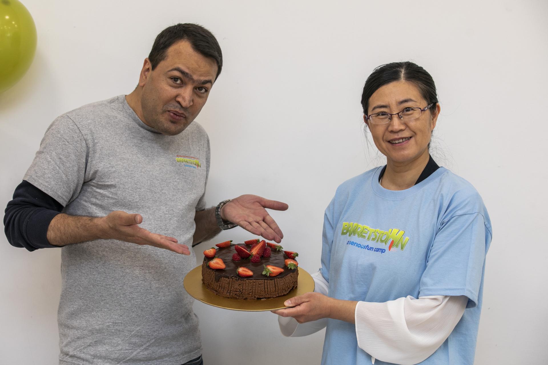 Shows Yuhui with her Raspberry Chocolate Layer Cake during the DCU Bake off for Barretstown