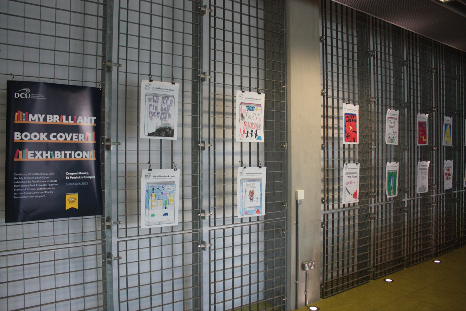 A wall grid with a poster and pictures hung on it